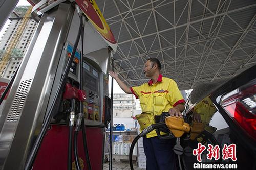 資料圖：一加油站工作人員給車輛加油。中新社記者張云攝